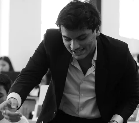 A delegate leans in to speak during a session